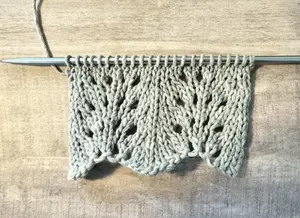 Close up view of the feather and fan knit stitch pattern