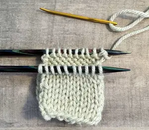 The Kitchener Stitch is a way to join two sets of live stitches creating an invisible, stretchy bind-off perfect for socks, shoulder seams, and mittens