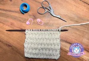 A knitted swatch of the Roman knit rib stitch shown in a beige color