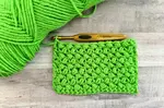 The crochet bean stitch creates a lovely textured fabric that appears as a zigzag puff stitch. Learn how tto make this easy, beginner-friendly stitch.
