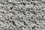 Crochet blanket stitch pattern worked in a light gray, worsted weight yarn.