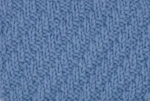 Right side showing of a swatch of the diagonal rib stitch worked in blue