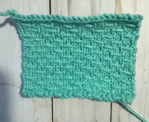 A swatch of the double woven knit stitch worked in a teal color