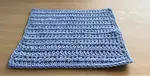 A forked half double crochet washcloth worked in 100% cotton