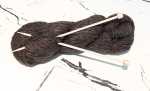 A hank of 100% alpaca yarn with knitting needles