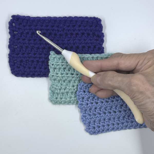 Addi Swing Ergonomic crochet hook used to make three swatches