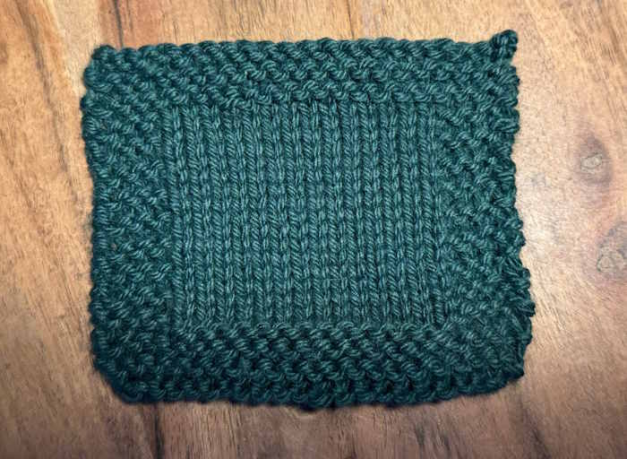 A Knitted Swatch of Berroco Vintage Green worsted weight yarn