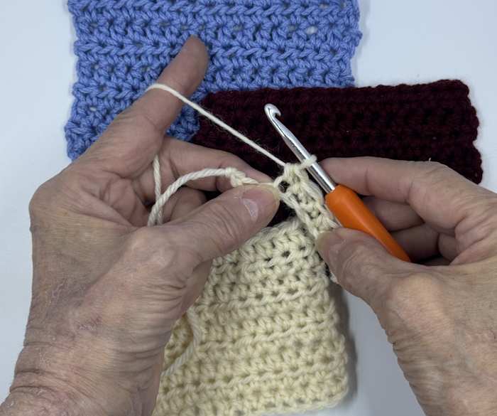 A Boye ergonomic crochet hook is used to create small swatches of half double crochet stitches.