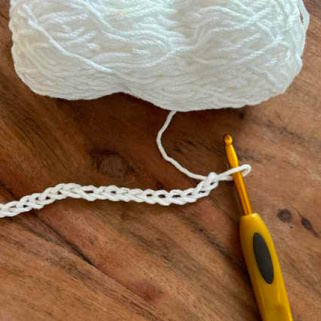 The crochet chain stitch shown with hook and yarn