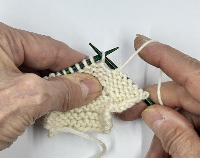 English style knitting is demonstrated with the yarn held in the right hand. English style knitting is demonstrated with the yarn held in the right hand.