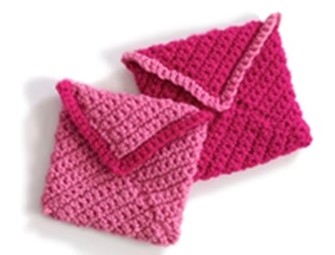 A crocheted envelop worked in pink yarn A crocheted envelop worked in pink yarn