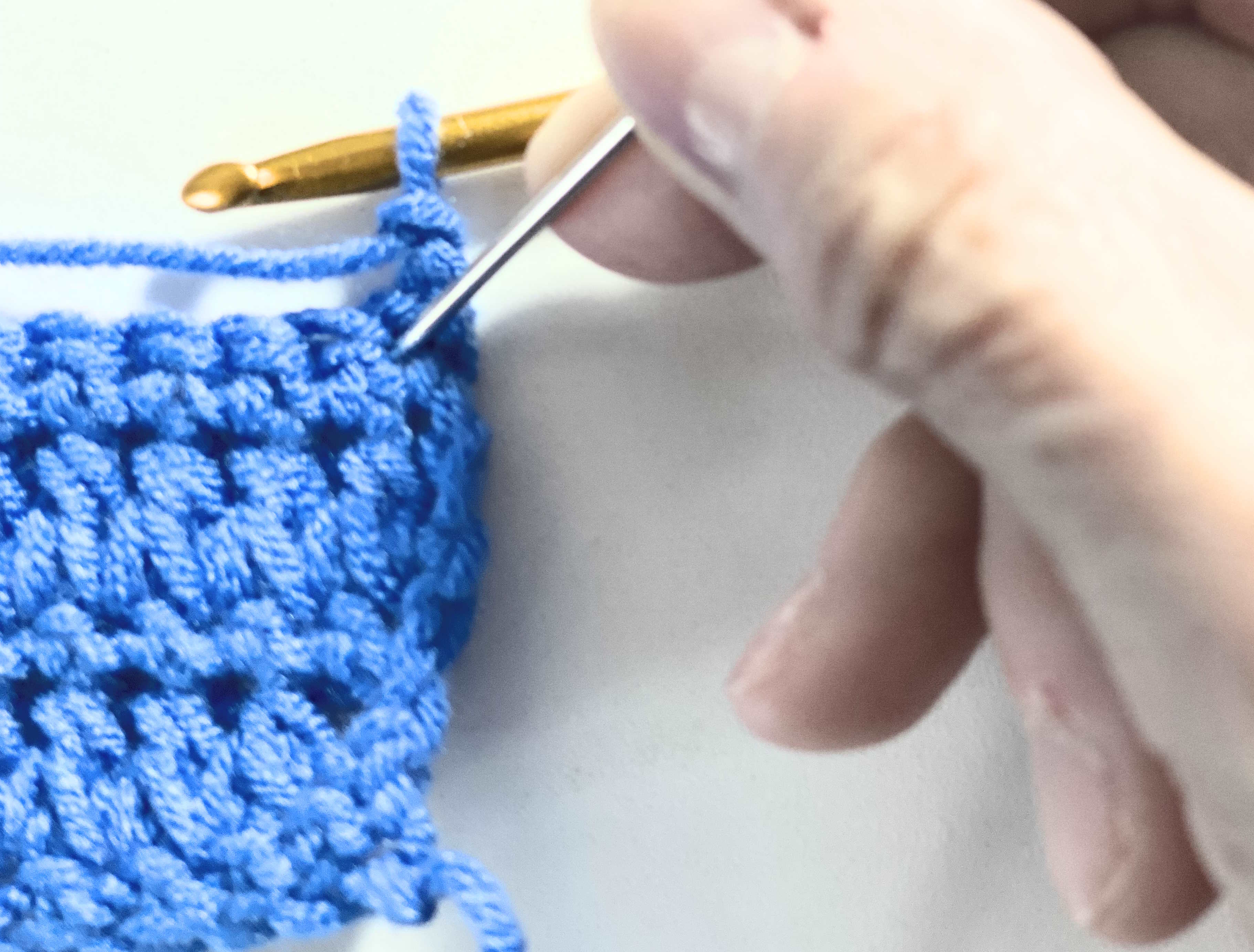 Step by step tutorial of the forked half double crochet  showing where to insert the hook.