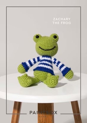 A small toy frog crocheted in several shades of green