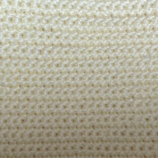 A swatch of half double crochet worked in white yarn