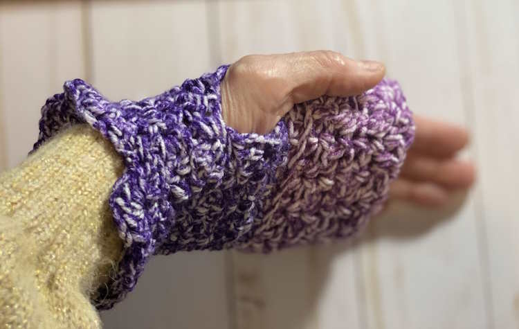 Half double crochet v stitch gloves worn by a woman