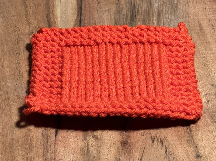 Swatch done in orange I love this yarn, worsted weight yarn.