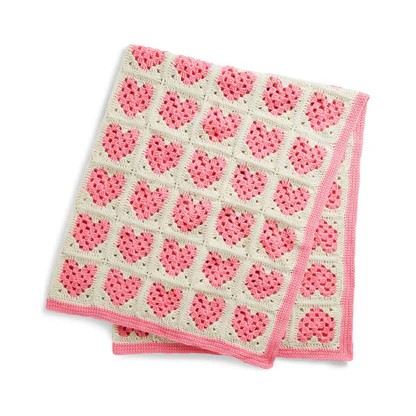 Pink hearts on a pink and white crocheted blanket Pink hearts on a pink and white crocheted blanket