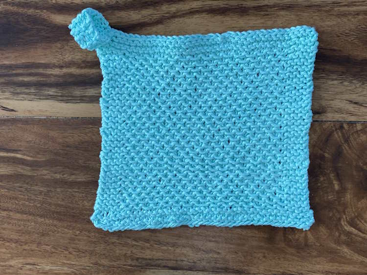 A completed stamen stitch washcloth worked in 100% cotton