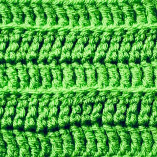 A swatch of treble crochet worked in green yarn