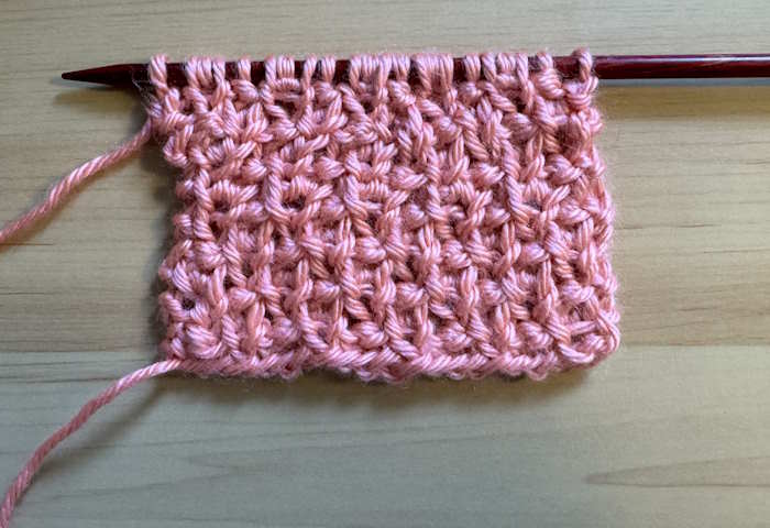 The wrong side is showing on a Trinity knit stitch pattern swatch