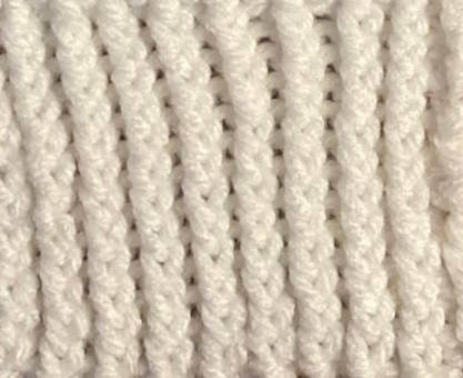 Twisted rib stitch pattern worked in white acrylic yarn, right side Twisted rib stitch pattern worked in white acrylic yarn, right side