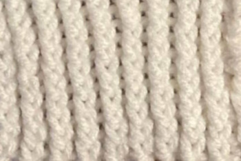 Twisted rib stitch worked in cream colored yarn
