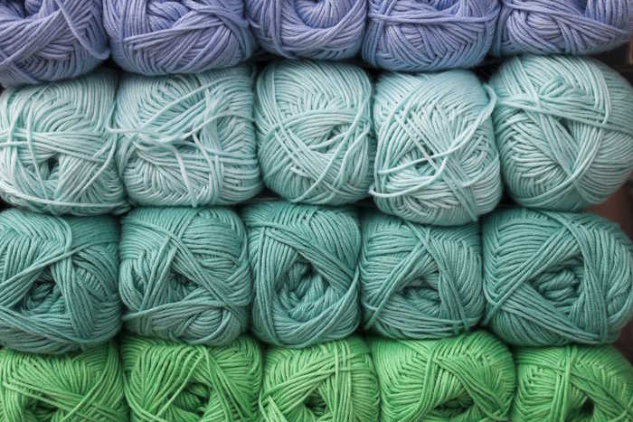 Stacks of acrylic yarn skeins in shades of blue and green Stacks of acrylic yarn skeins in shades of blue and green