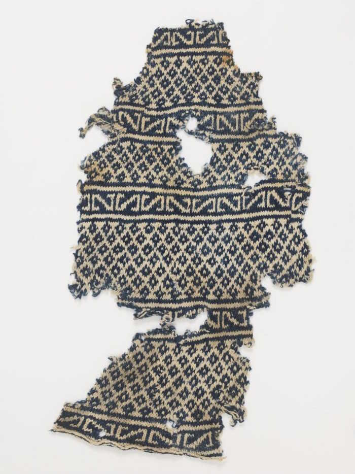 Ancient fragment of a knit blue and white sock made in Africa around 1100 to 1300 