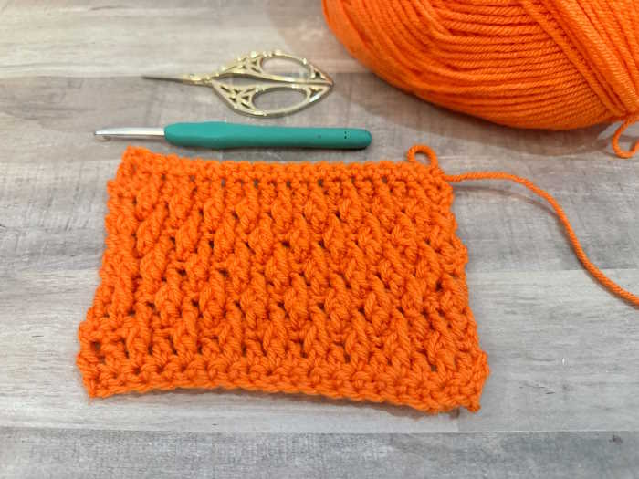 A swatch of the crochet alpine stitch shown in orange yarn A swatch of the crochet alpine stitch shown in orange yarn
