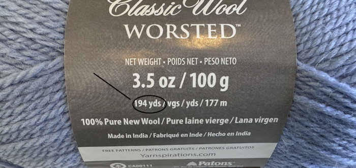 The front side showing of the ball band surrounding Paton's Classic Wool Worsted