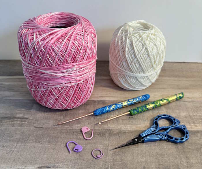 Balls Wrapped Around a Hard Cardboard Core Ball of crochet cotton thread shown with crochet hooks