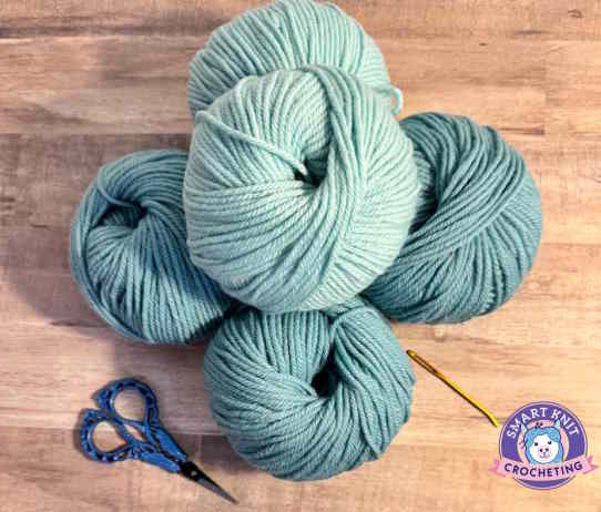 Several balls of teal yarn arranged on a table