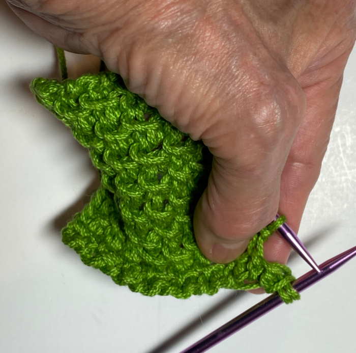 Yarn over and then knit 2.  Pass the YO stitch over the knit 2 and off the needle.  