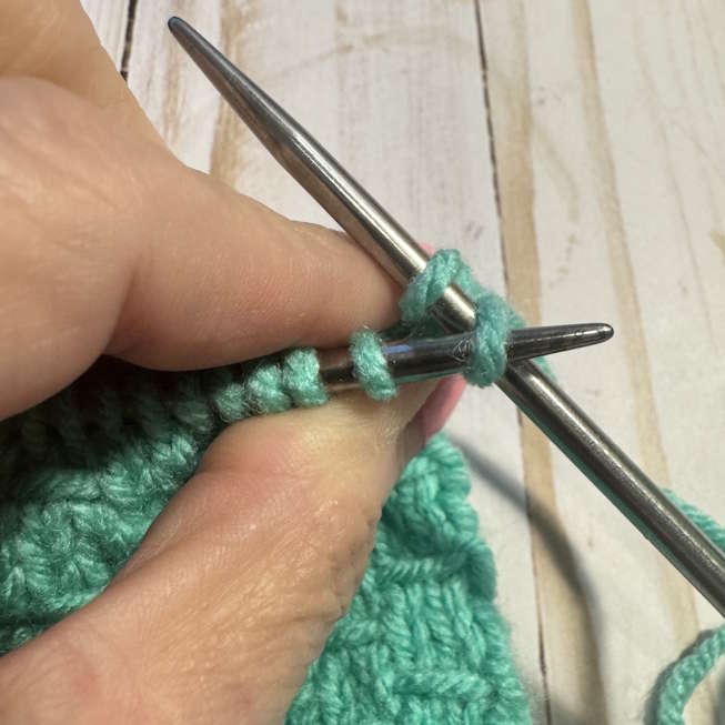 To bind off, knit two stitches, then lift the first stitch over the second and off the needle.