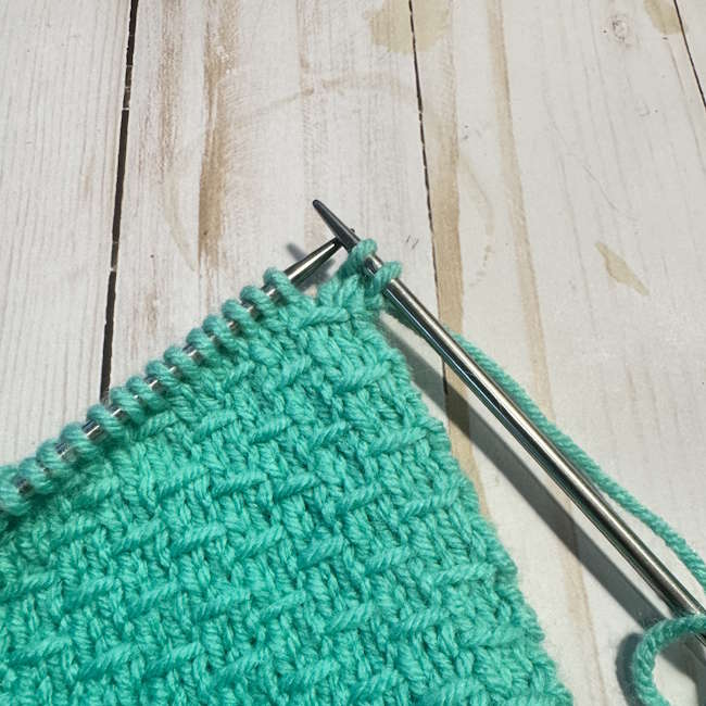 Begin the bind-off row by knitting (or purling) two stitches