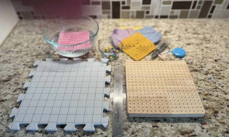 blocking crochet showing various supplies needed to block using a wet blocking method