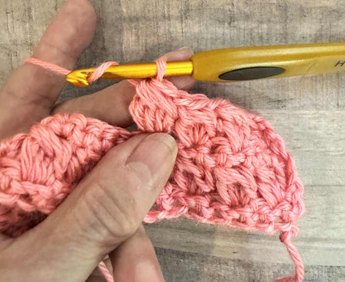 Crochet bobble stitch showing pulling through five loops on hook