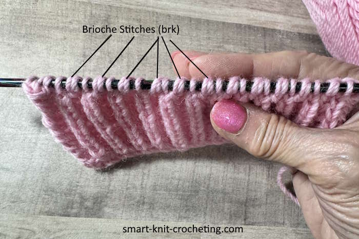 The brioche stitch on the needle showing the individual brioche stitches