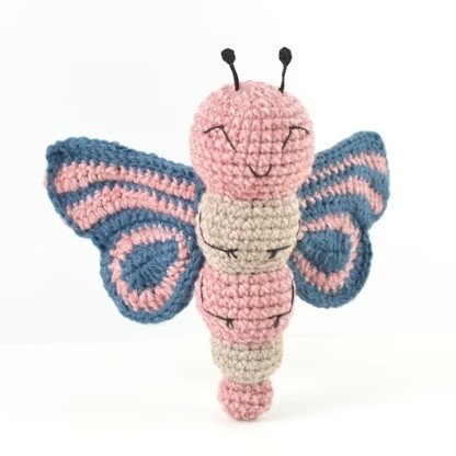 A butterfly toy crocheted in pink and purple yarn
