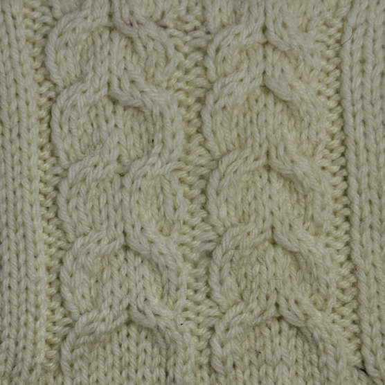 A cable swatch of the horseshoe pattern worked in a white yarn.