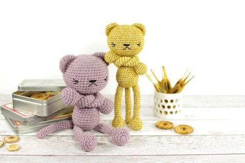 Two long legged cats crocheted and posing for the camera