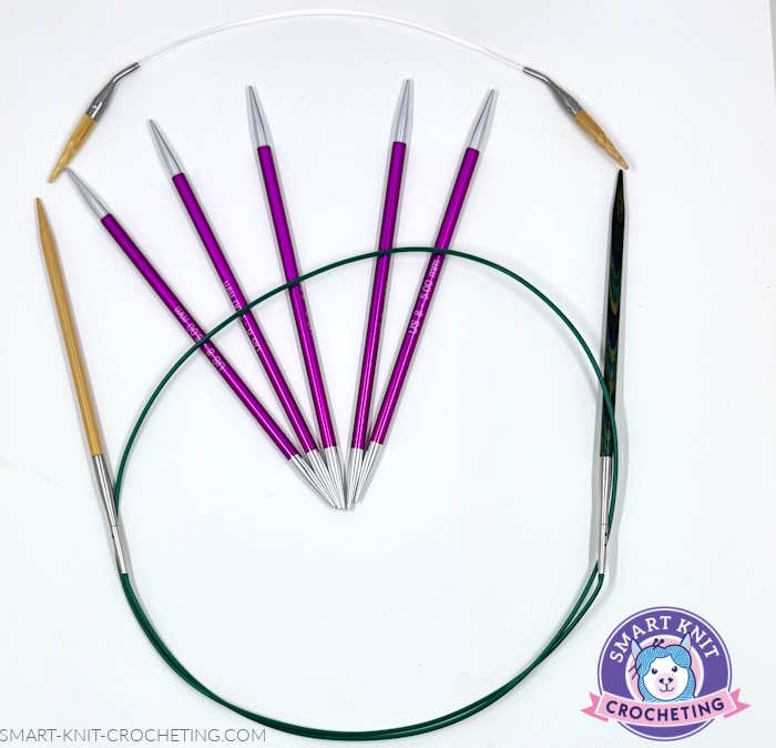 An assortment of needles:  small circular needle, double pointed needles, a large cable attached to needle tips