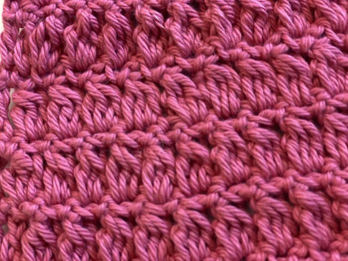 Cluster Stitch swatch worked in pink yarn