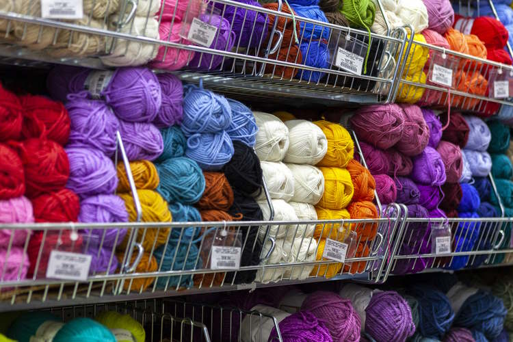 yarn shop showing shelves of yarns yarn shop showing shelves of yarns