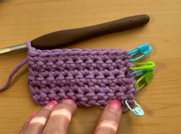 Stitch markers are used to identify rows in this small crochet swatch Stitch markers are used to identify rows in this small crochet swatch