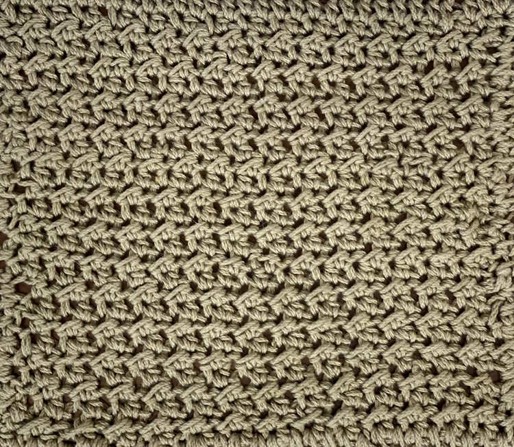 A swatch of the crochet crunch stitch worked in olive green cotton yarn