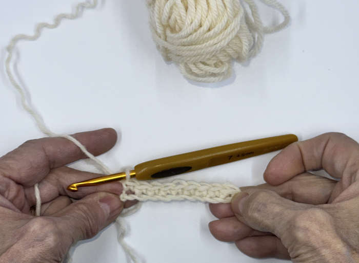 Foundation chain and first row of crochet stitches completed before starting the second row