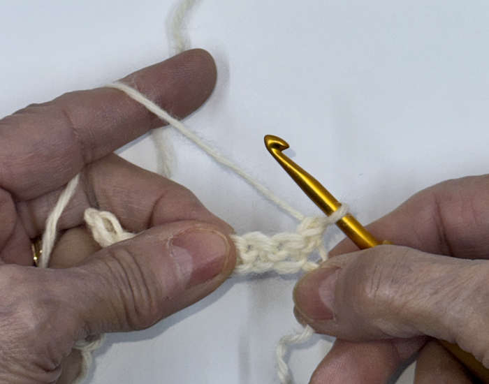 Turning the crochet work at the end of the first row to begin the second row