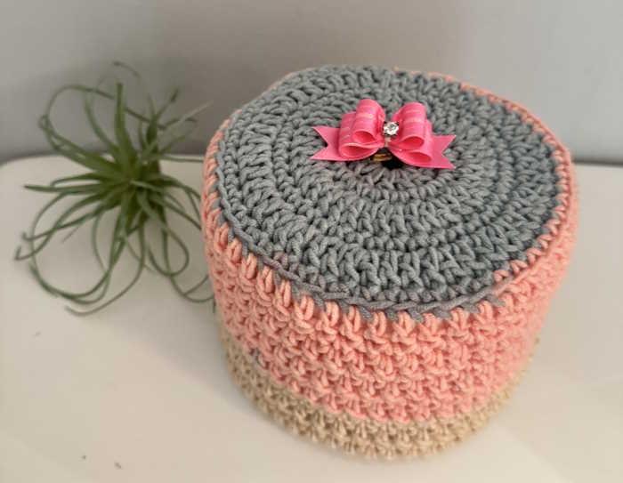 The finished product of a crocheted toilet paper cover The finished product of a crocheted toilet paper cover