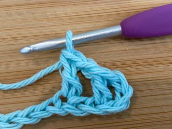 4.  Chain one.  Make one more double crochet stitch into the same space as the last one.